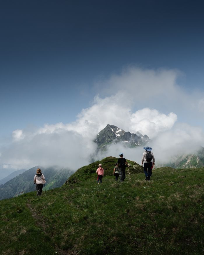 Group exploring a misty mountain trail with stunning views, embodying outdoor adventure.